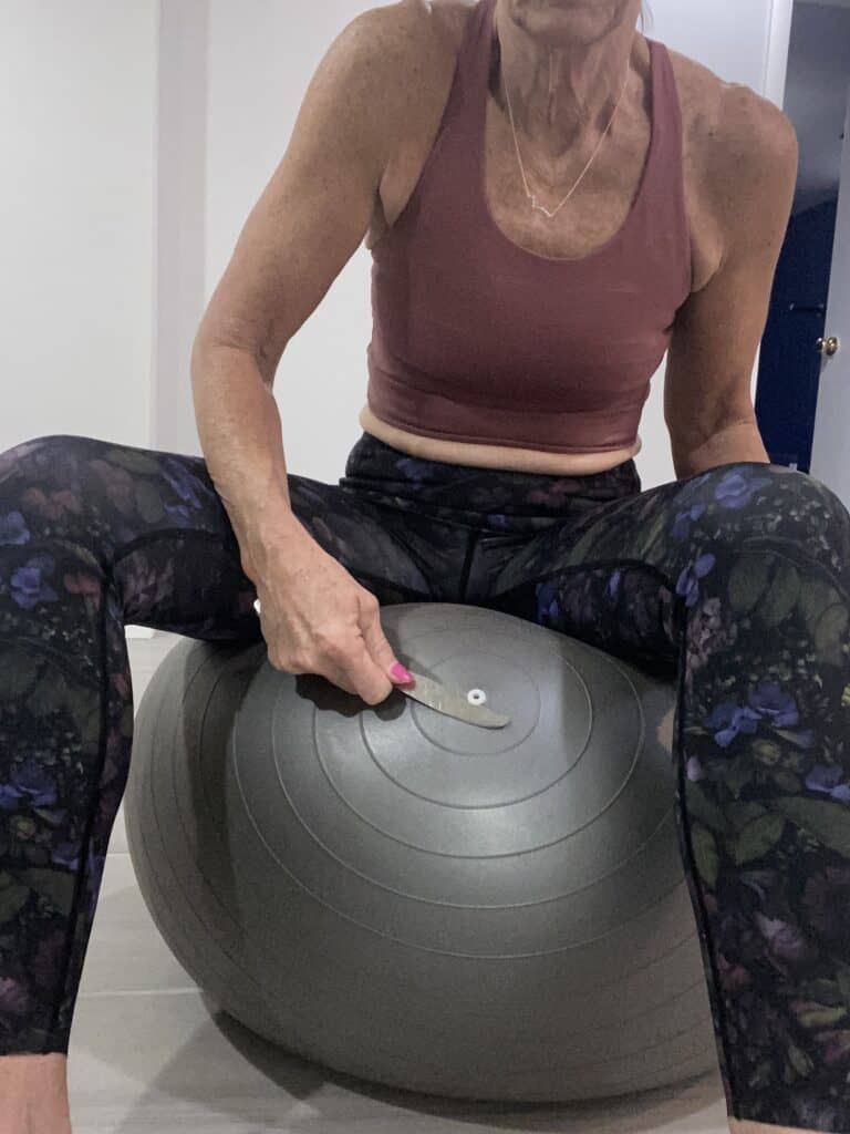 sitting on exercise ball to release the plug