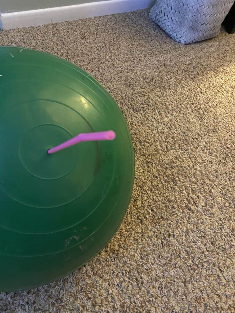 using a straw to inflate an exercise ball