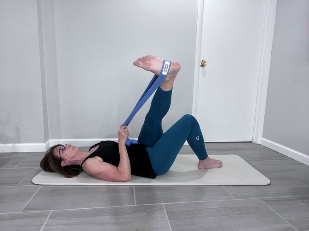 IT band stretch with yoga strap
