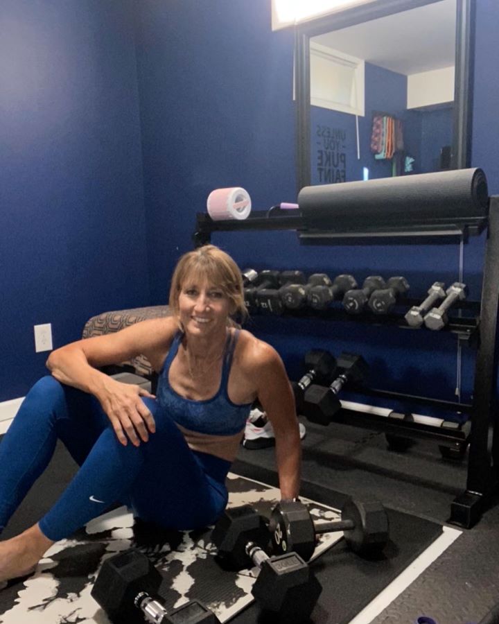 Person exercising with dumbbells at home.  Exercising after illness or injury